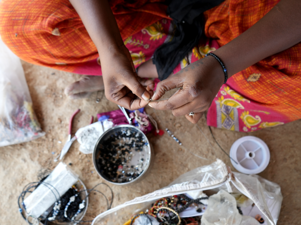 Close shot of a woman's hands stringing beads